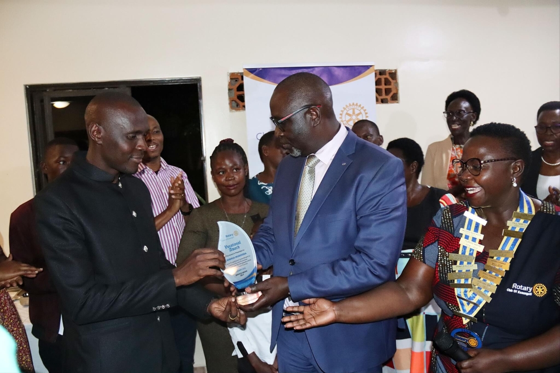 Owek. Robert Waggwa presents an award to Preacher Joshua Mugooda in recognition of his service to the community Image